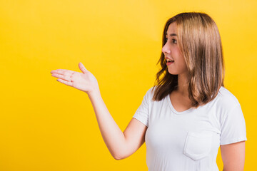 woman teen standing holding something on palm and point away side