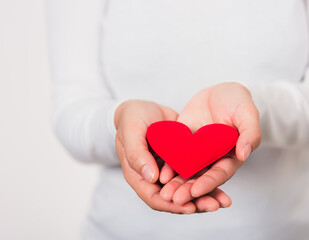Woman beauty hands holding red heart for giving