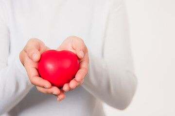 Woman beauty hands holding red heart for giving