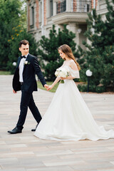 The groom and the bride walk outdoors. first meeting before the wedding ceremony