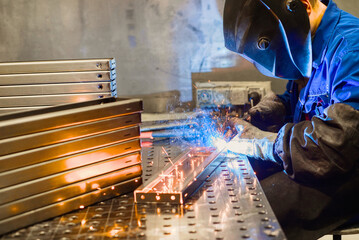 Working welder welds parts factory