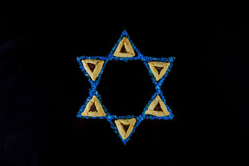 Jewish holiday background with hamantaschen cookies and star of David.