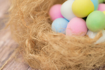 Easter image with Close Up Colorful Egg Chocolates on the Nest with Copy Space