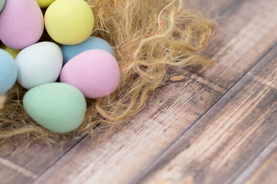 Easter image with Close Up Colorful Egg Chocolates on the Nest with Copy Space