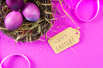Colorful background with Easter eggs on pink background. Happy Easter concept. Can be used as poster, background, holiday card. Flat lay, top view, copy space. Studio Photo
