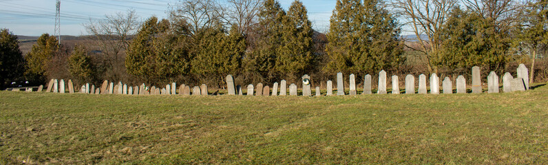 Old abandoned cemetery with Tombstones in a row .