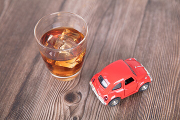 A glass of wine and a model car