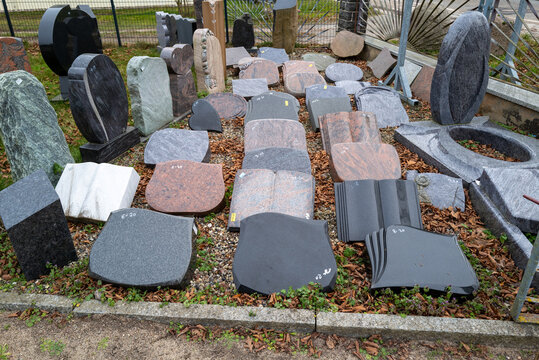 in a yard of a stonemason's workshop there are many different gravestones next to each other