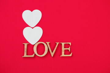 Valentine card background idea, love wooden font with white wood heart shape on red background, love and romance concept