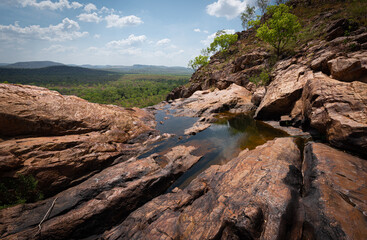 Fototapeta na wymiar Rock pool high above the trees on a clifftop