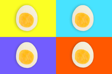 Four cut boiled easter eggs on yellow, purple, orange and blue pop-art backgrounds