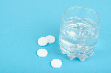 White round tablets, soluble in glass of water. Studio Photo