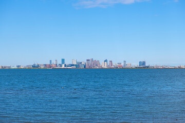 Boston financial district modern city skyline and Logan International Airport by the sea from Deer Island, Boston, Massachusetts MA, USA. 