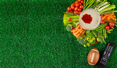 Colorful vegetable platter with football ball for american football game party. © Olesya