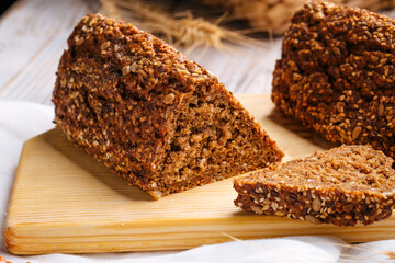 Side on sliced triangle flourless diet grain bread on wooden board
