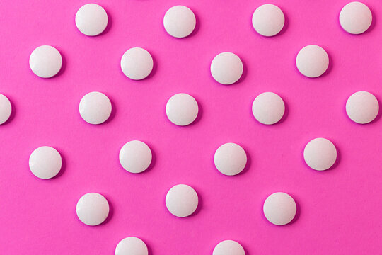 Image of a row of pills, drugs, and tablets. Place them on a colorful surface layer.