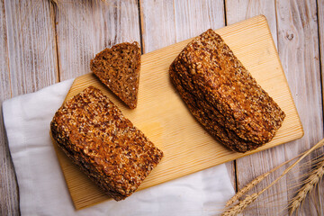 Top view on sliced triangle flourless diet grain bread on wooden board