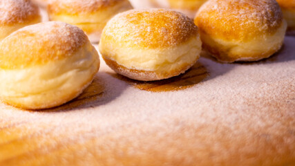 side angle close up a pile of doughnut with icing sugar in wooden table