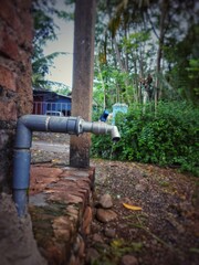 A drop of water dripping from the tap. Selective focus