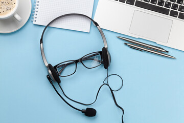 Office desk with headset and laptop. Work from home