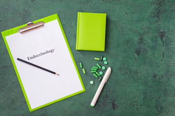 Clipboard with word ENDOCRINOLOGY and pills on color background