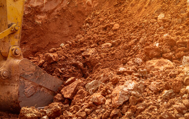 Backhoe bucket digging the soil at agriculture farm to make pond. Crawler excavator digging at shale layer. Excavating machine. Earth moving equipment. Excavation vehicle. Construction business.