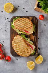 Sandwich with cheese, tomato and fresh salad, made of whole wheat bread with a crispy crust on a...