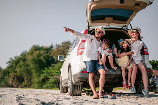 Happy Asian Family Enjoying Road Trip With Their Favorite Car. Parents And Children Are Traveling The Way To The Sea Or Ocean.Holiday And Travel Family Concept, Summer Vacations.