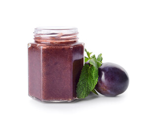 Glass jar with delicious homemade plum jam on white background