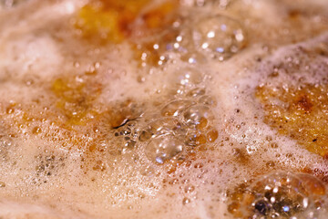 Close-up on frying cutlets with bubbles.