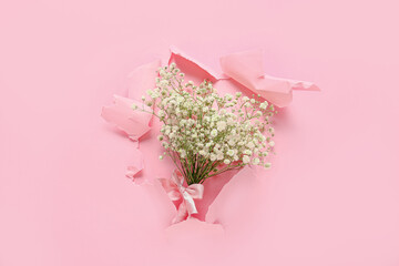 Bouquet of beautiful flowers on color paper background