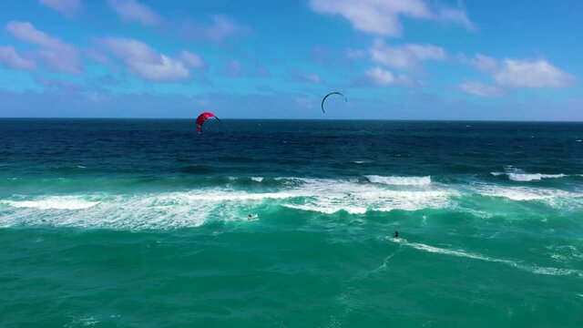 Two kite surfers in the Atlantic Ocean on a beautiful day.