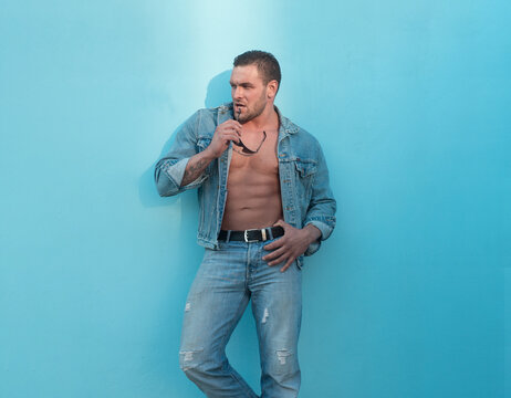 Man jeanse street style. Naked male body. Sexy muscular guy. Nude abs.