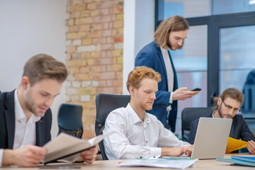 Fototapeta premium Group of men concentratedly busy in office