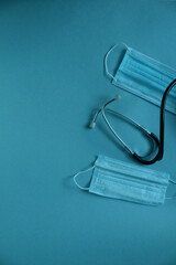 background of the medical mask and stethoscope on a blue blue background with a place for the text of the copyspace