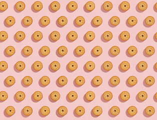 Fototapeta na wymiar Biscuits stuffed with cream on a bright pink background, a recurring seamless pattern, sweet background, wallpaper. Copy space, banner. top view
