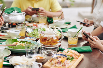Various drinks and dishes on big dinner table served for Lunar New Year celebration dinner