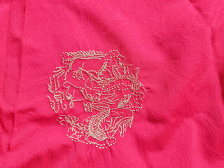 Red clothes with golden embroidered dragon