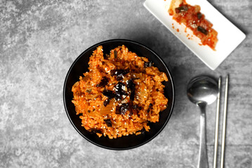 Top view Korean kimchi fried rice topping white sesame and seaweed