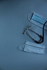 background of the medical mask and stethoscope on a blue blue background with a place for the text of the copyspace