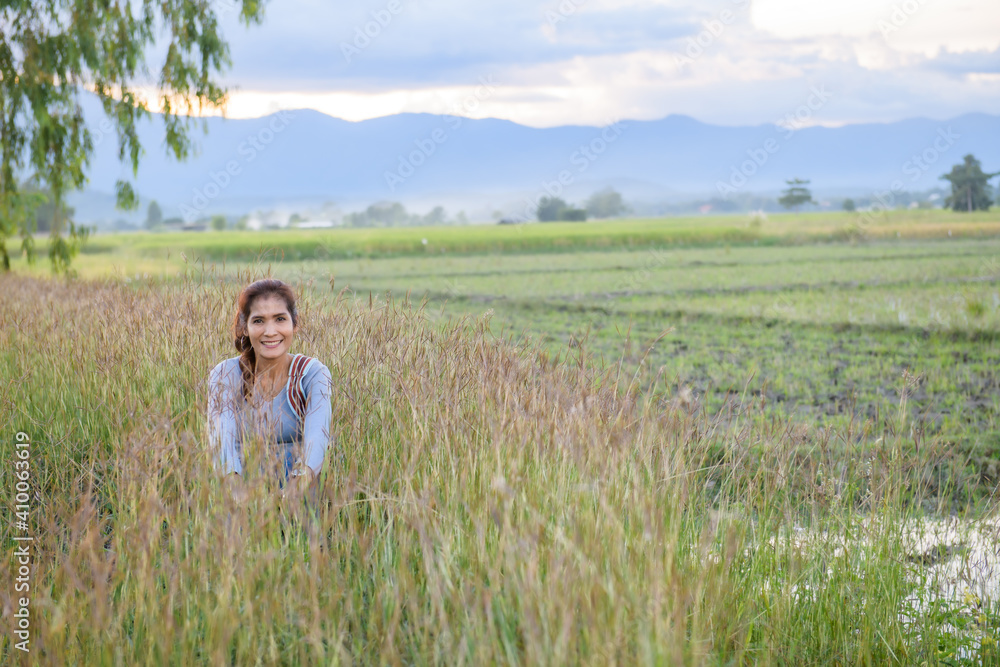 Canvas Prints A woman is sitting in the rice field