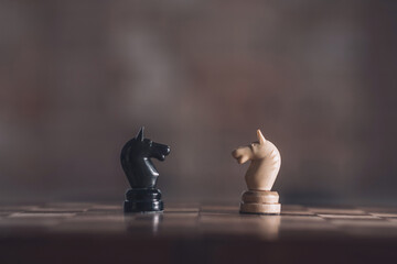 Two chess knights facing each other © zinkevych