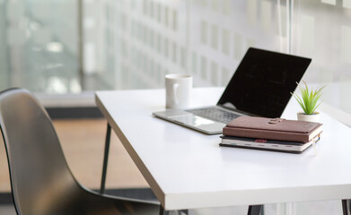 Cropped shot of Notebooks and laptop on the desk in a modern office.