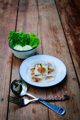 Selective focus of Thai steamed rice-skin dumplings or khao kriap pak maw is tow popular and unique Thai street food snacks ,
thai style dessert on wooden