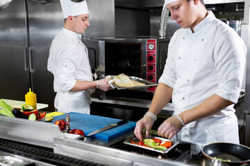 Chefs prepare meals in the kitchen