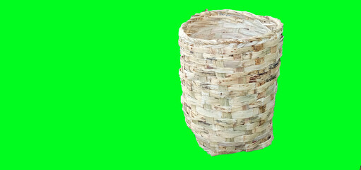Woven cane bark into basket with green background