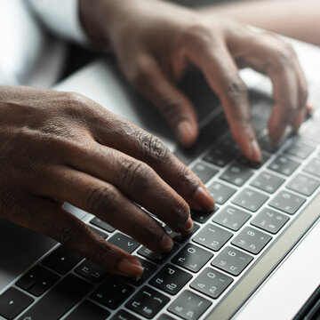 Woman typing on a laptop keyboard