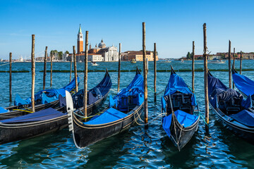 Empty gondolas near St. Mark's Square with the Church of San Giorgio Maggiore in the background, Venice, Italy