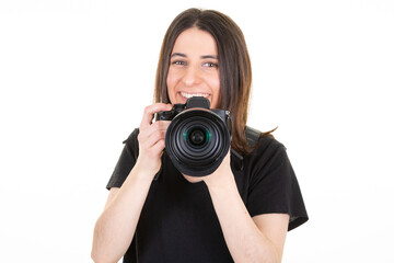 Young woman with black professional digital SLR camera over white background