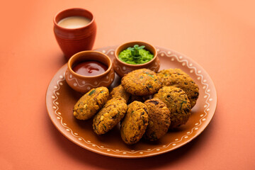 Parippu or Paruppu Vadai or Masala Chana Dal Vada served in a plate with ketchup